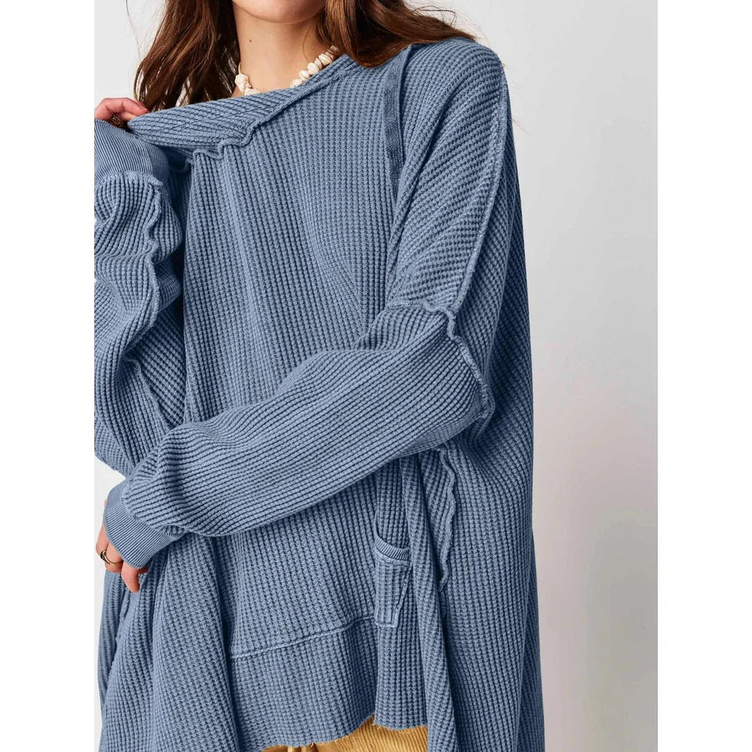A cosy, oversized black hoodie with pockets, perfect for keeping warm during the autumn and winter seasons in the UK.
