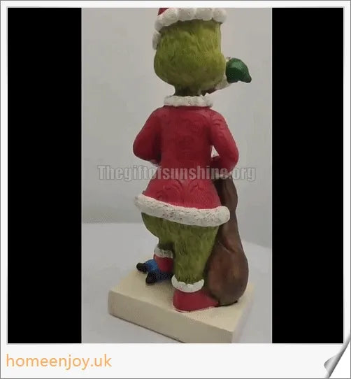 A resin garden statue depicting the Grinch sneakily enjoying a snack, surrounded by a group of jolly gnomes.