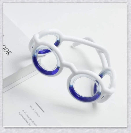 A pair of black motion sickness glasses with a blue liquid-filled ring to create an artificial horizon and relieve nausea, dizziness, and vertigo during travel.