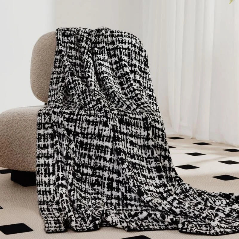 Cosy wearable wool blend travel blanket with timeless black and white striped pattern