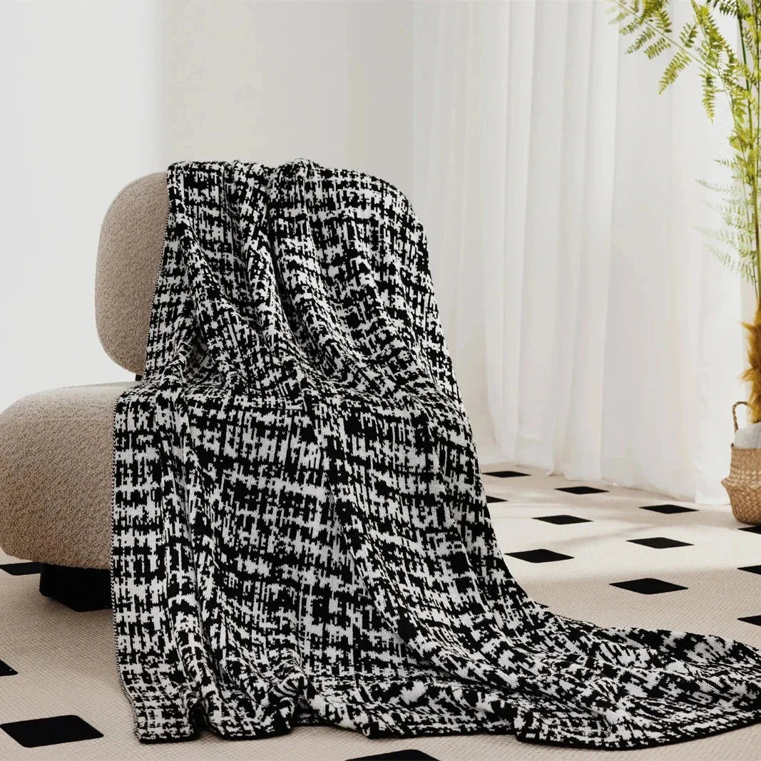 Cosy wearable wool blend travel blanket with timeless black and white striped pattern