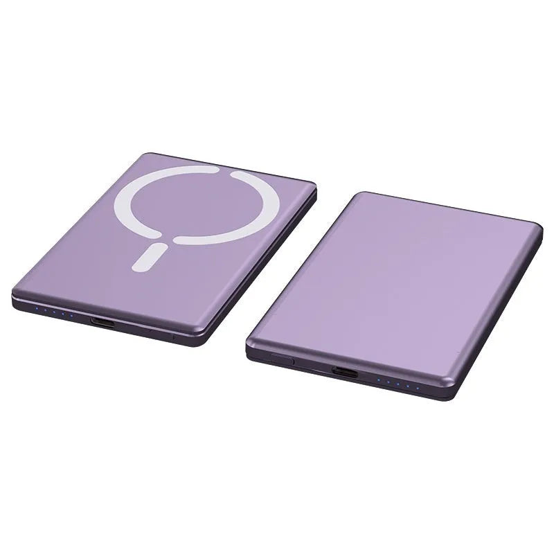 Slim dark grey magnetic power bank attached to the back of an iPhone, showing its thin profile and metallic finish.