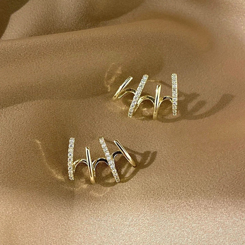 Pair of 925 sterling silver earrings with four-prong zircon stone settings in a geometric design