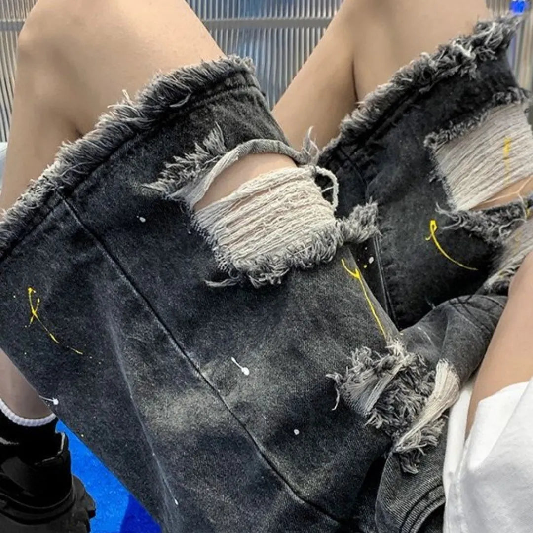 Man wearing loose-fit light blue water-washed denim shorts with a fifth pants length, showing street style.