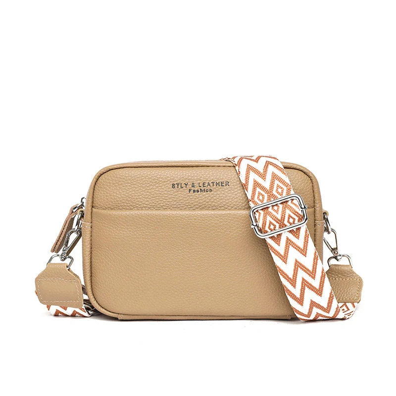 Stylish crossbody bag with rhombus embroidery, wide adjustable shoulder strap, and multiple interior pockets in various color options