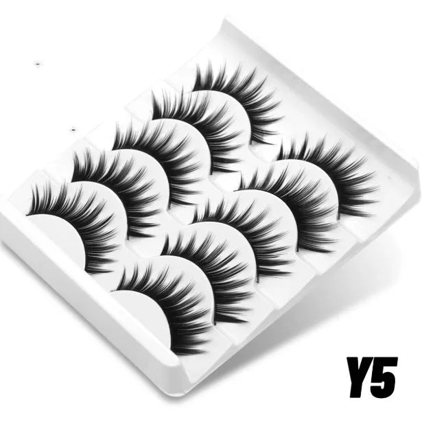 Box containing six pairs of black artificial fibre false eyelashes with different styles and a tube of clear lash glue.