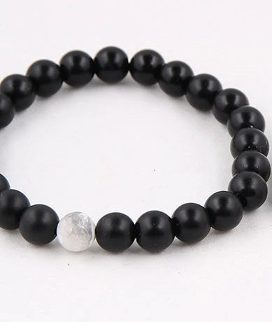 Handcrafted beaded bracelet with seven chakra-representing beads, designed to promote balance and well-being.