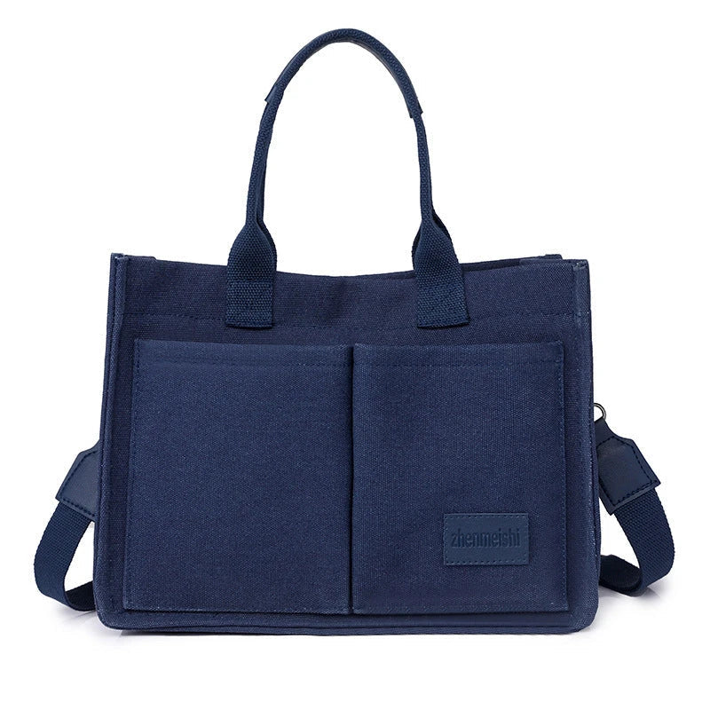 Premium canvas tote bag with multiple pockets, adjustable shoulder strap, and stylish design for everyday use