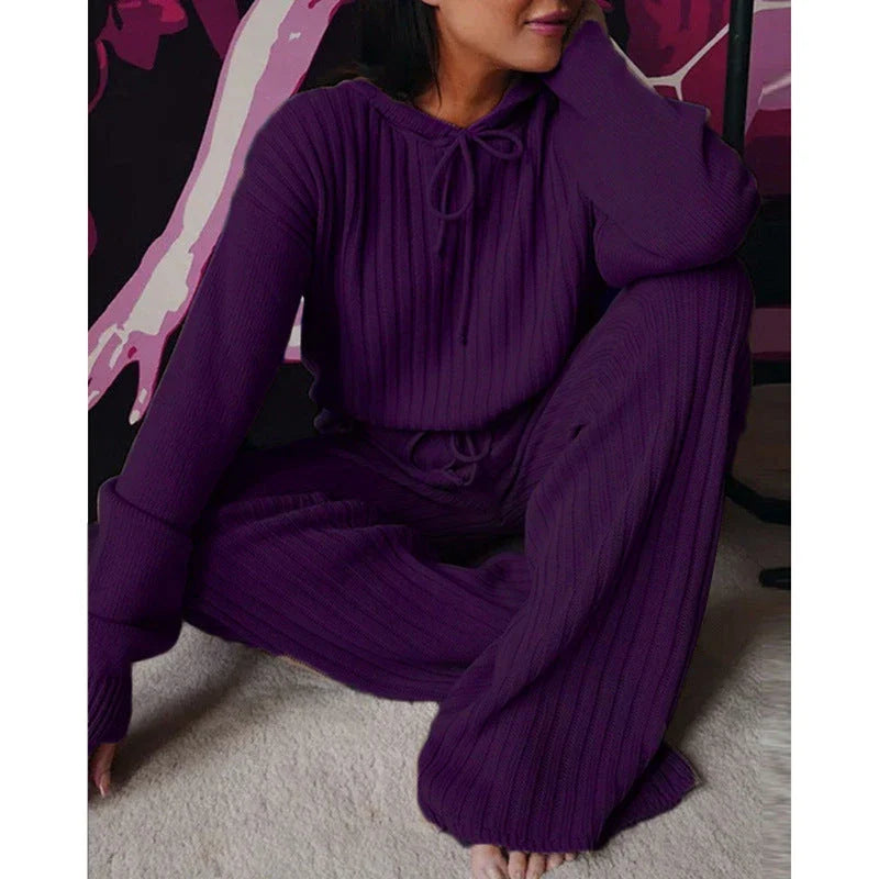 A stylish two-piece casual set featuring a hooded top with long sleeves and matching bottoms in a variety of vibrant colors.