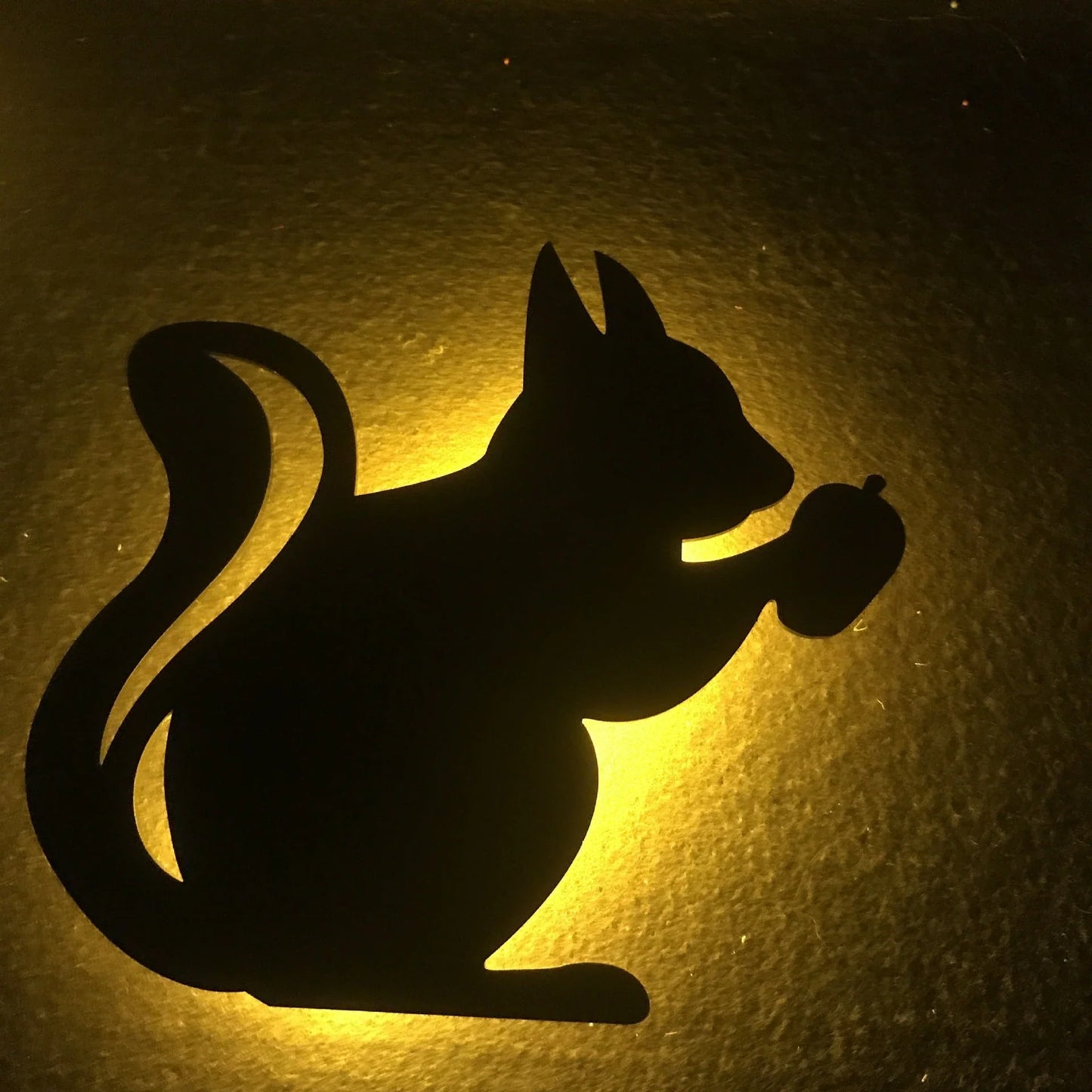 A stylish cat-themed LED lamp that automatically lights up when it detects sound, creating a cozy, ambient glow in a room.