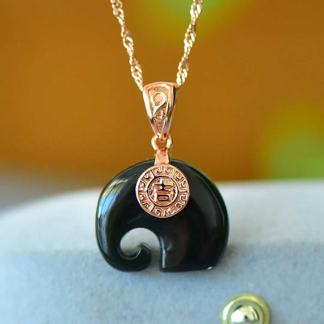 Copper inlaid pendant with natural grey Hetian jade and dark ink blue jade on a necklace.