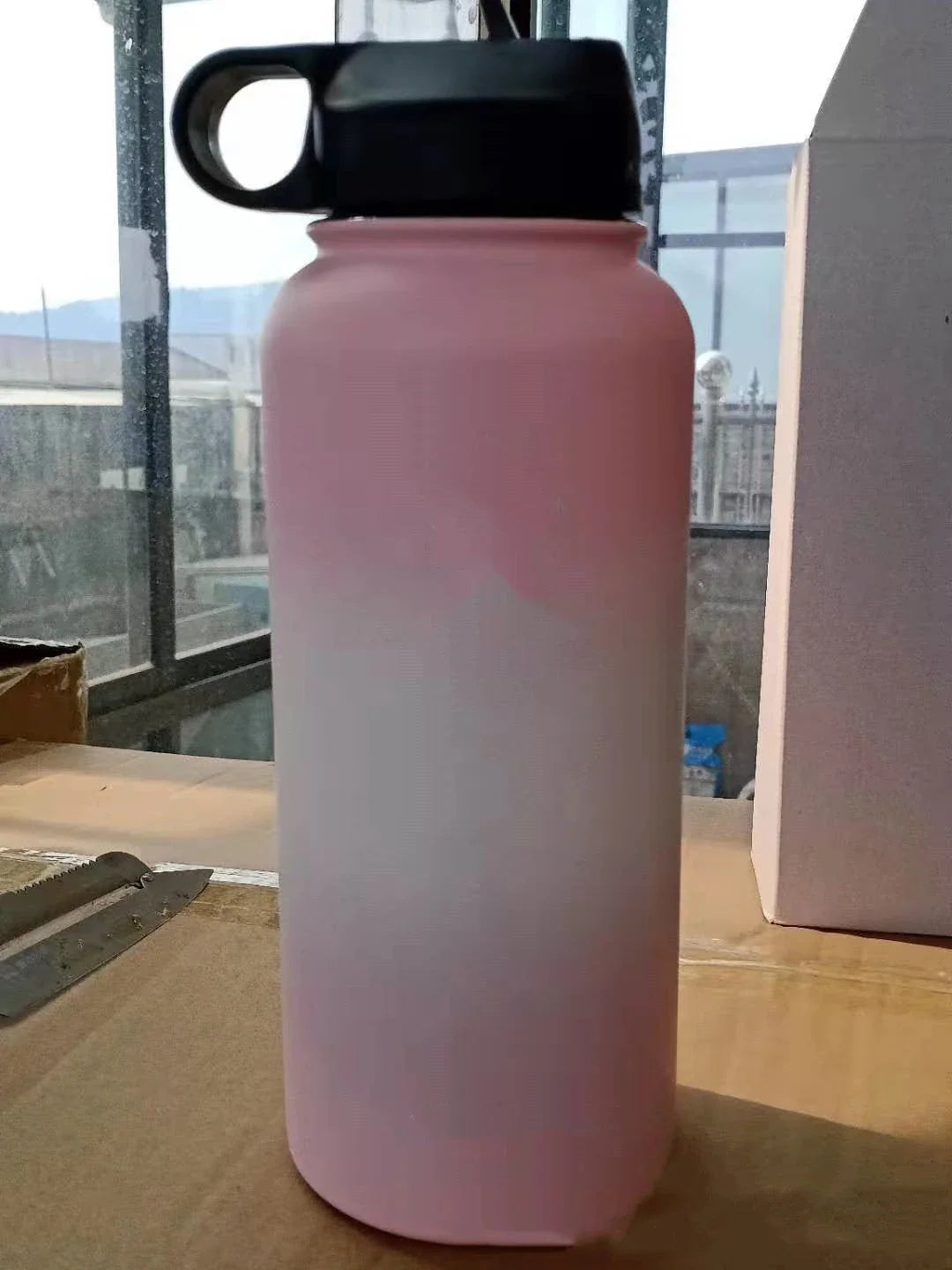 Stainless steel insulated water bottle with wide mouth and push-button lid for hot and cold beverages