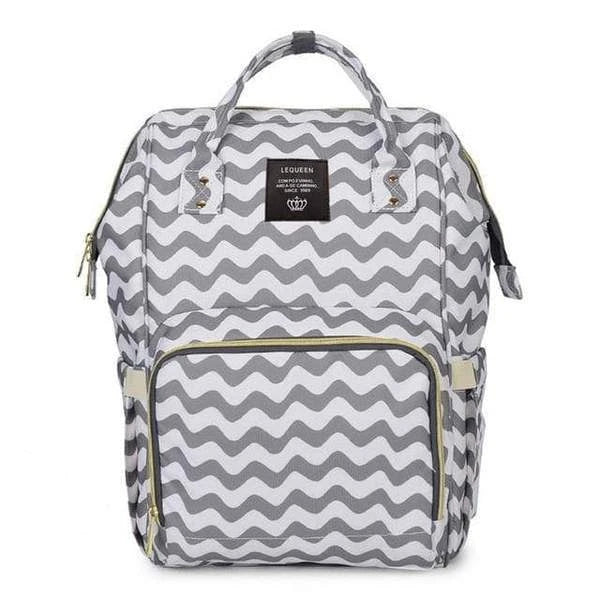 Stylish maternity diaper bag in various colors, featuring a paper bag design, separate bottle compartment, and discreet breastfeeding button.