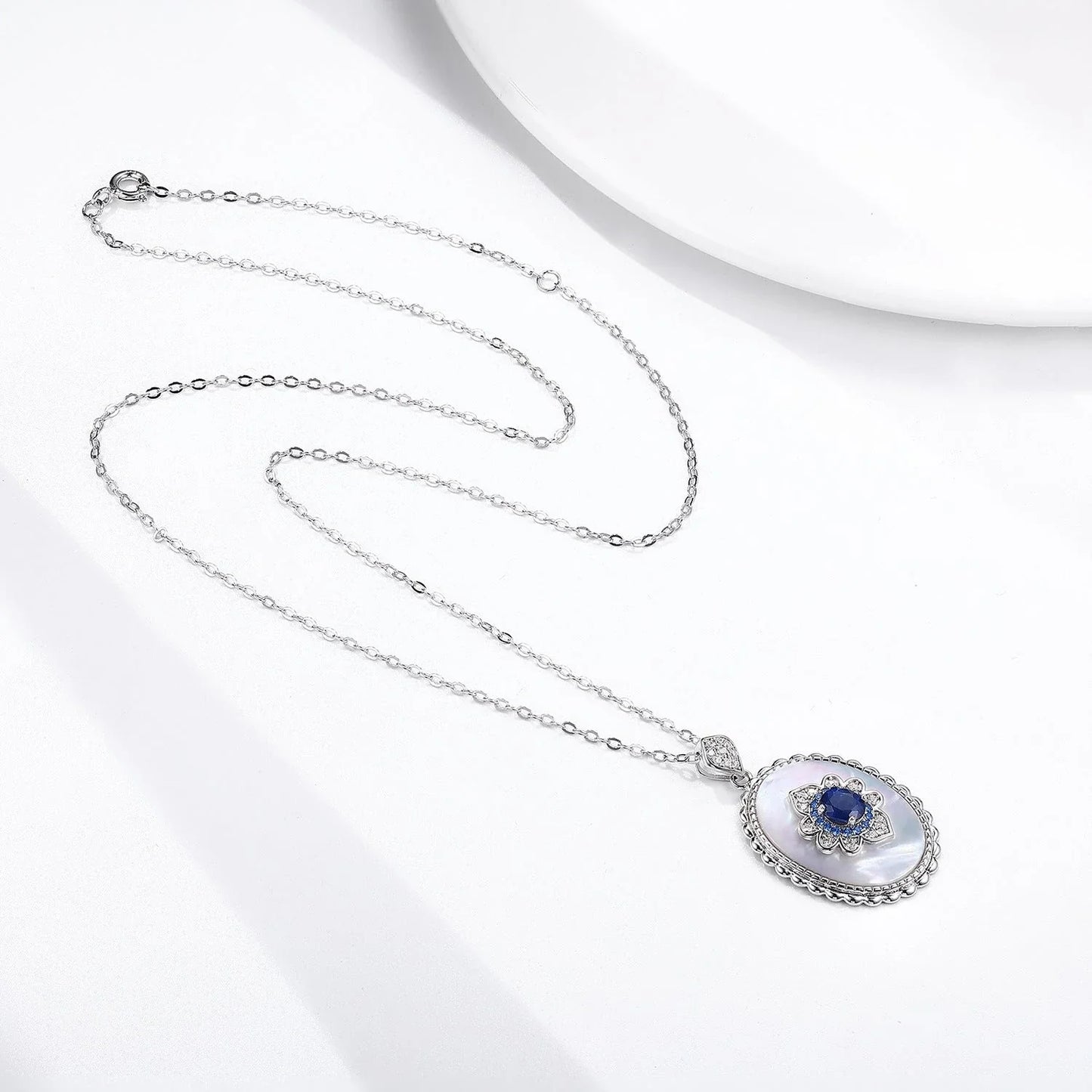 Elegant sapphire and diamond pendant necklace in 925 sterling silver, featuring a sparkling gemstone design and adjustable chain.