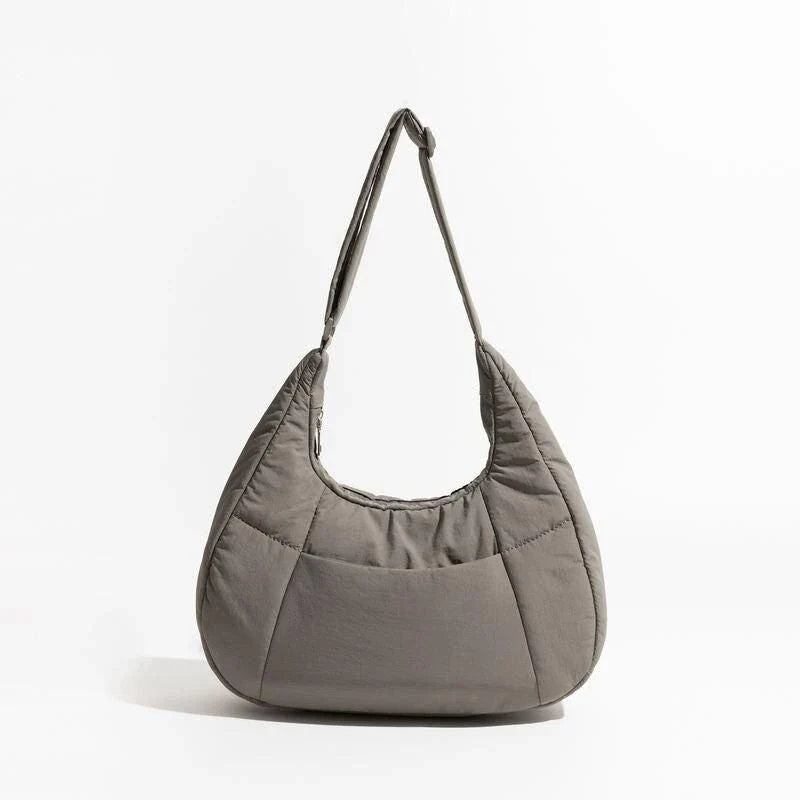 Chic Half Moon Puffer Shoulder Bag in Pink - Unique quilted design, secure zipper closure, and adjustable strap for everyday elegance