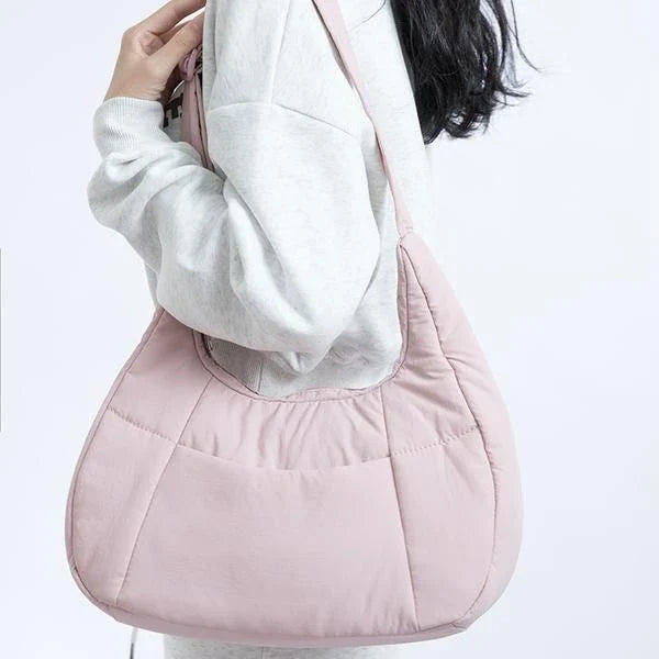 Chic Half Moon Puffer Shoulder Bag in Pink - Unique quilted design, secure zipper closure, and adjustable strap for everyday elegance