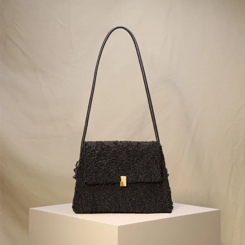A stylish faux lamb wool crossbody bag in a neutral colour, featuring a double strap design and multiple interior compartments for organised storage.