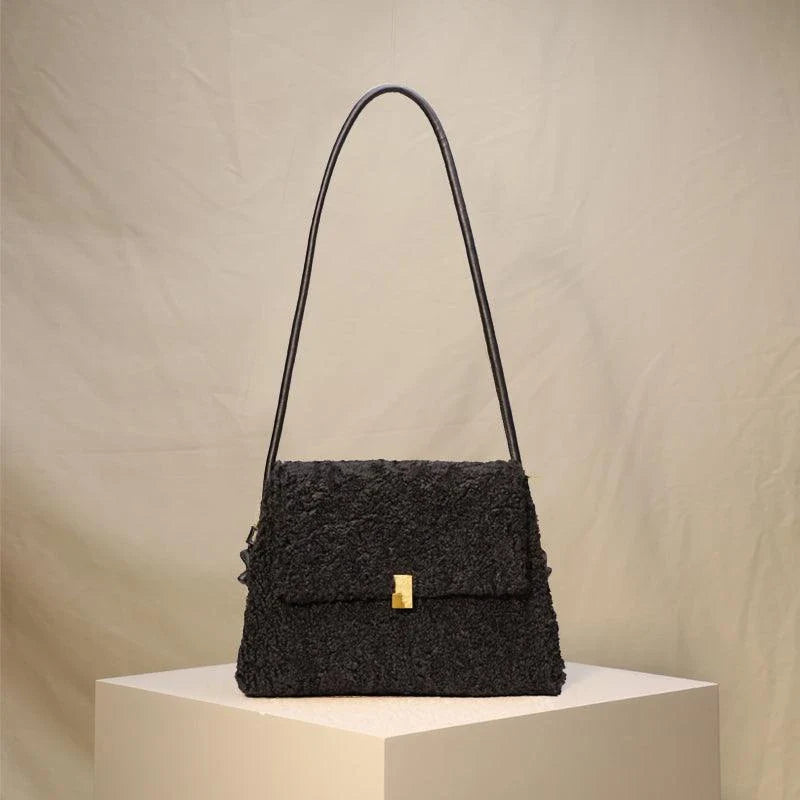 A stylish faux lamb wool crossbody bag in a neutral colour, featuring a double strap design and multiple interior compartments for organised storage.