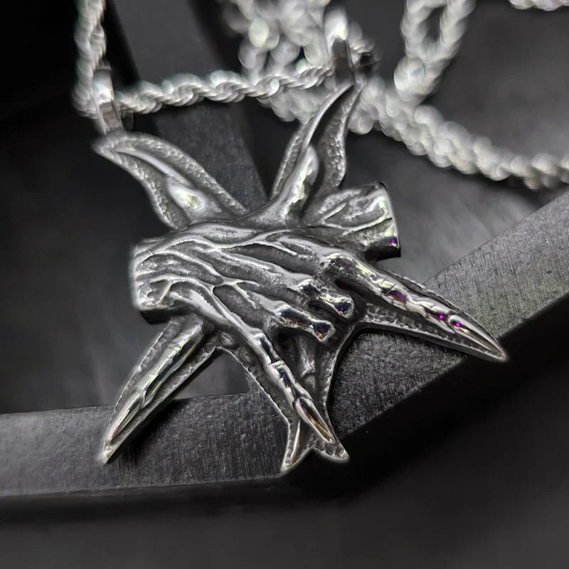 A close-up view of a three-dimensional pendant necklace made of titanium steel, showcasing its sleek and sophisticated design.