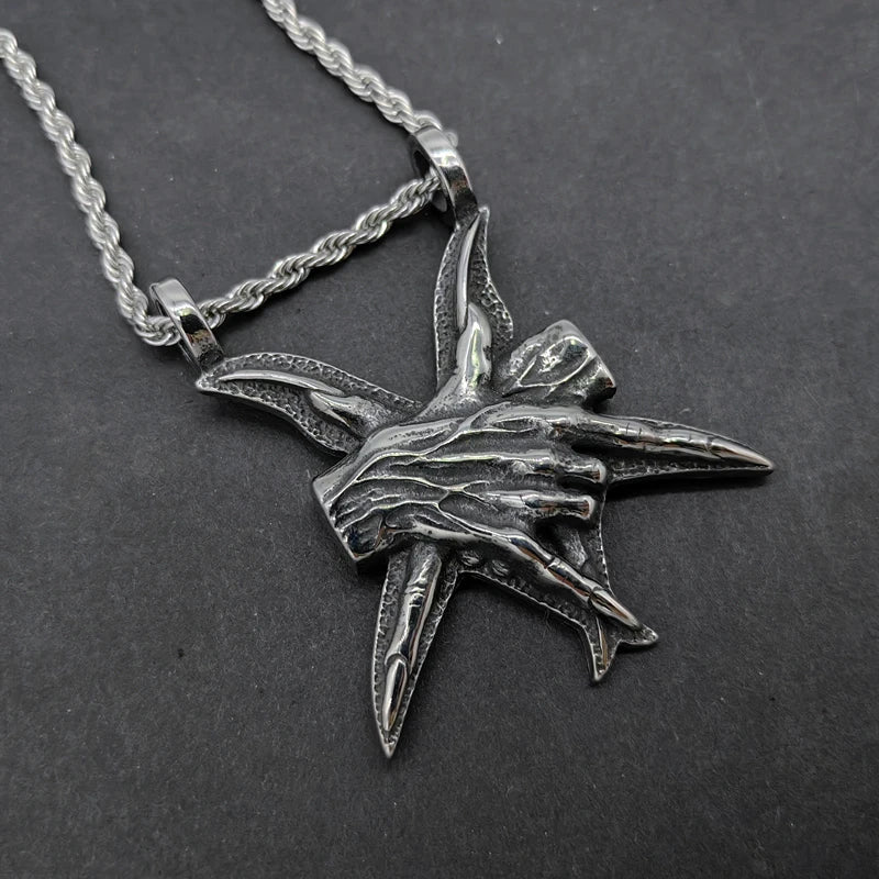 A close-up view of a three-dimensional pendant necklace made of titanium steel, showcasing its sleek and sophisticated design.