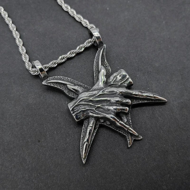 A close-up view of a three-dimensional pendant necklace made of titanium steel, showcasing its sleek and sophisticated design.