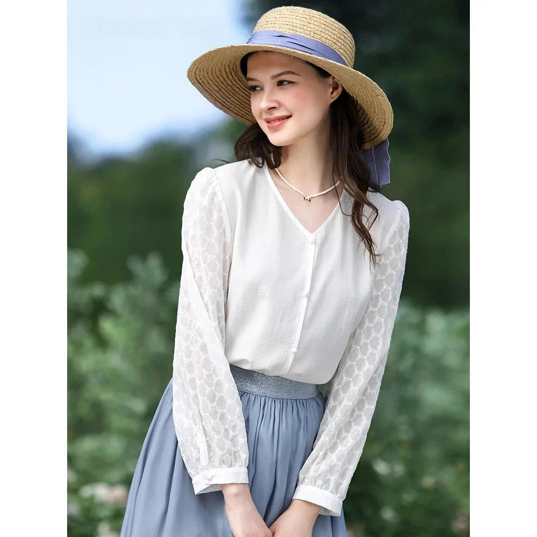 A French-inspired chic v-neck women's blouse in a crisp white colour, featuring a stylish spliced design and a flattering, tailored silhouette.