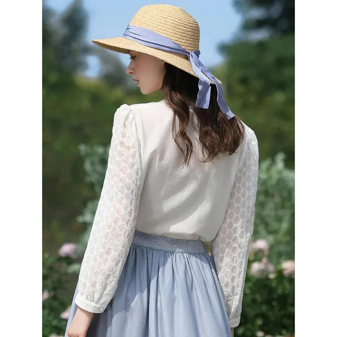 A French-inspired chic v-neck women's blouse in a crisp white colour, featuring a stylish spliced design and a flattering, tailored silhouette.