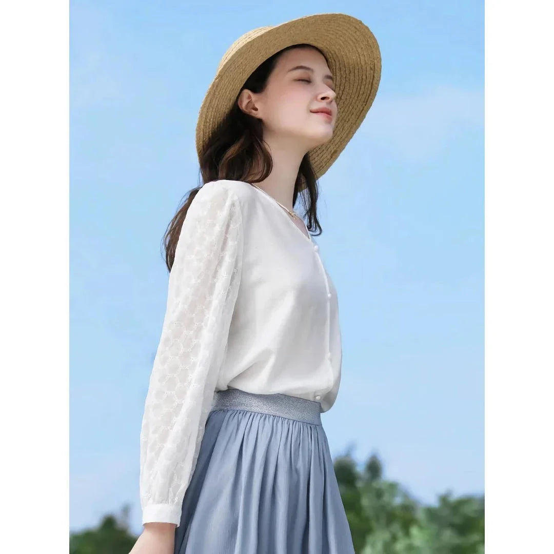 A French-inspired chic v-neck women's blouse in a crisp white colour, featuring a stylish spliced design and a flattering, tailored silhouette.