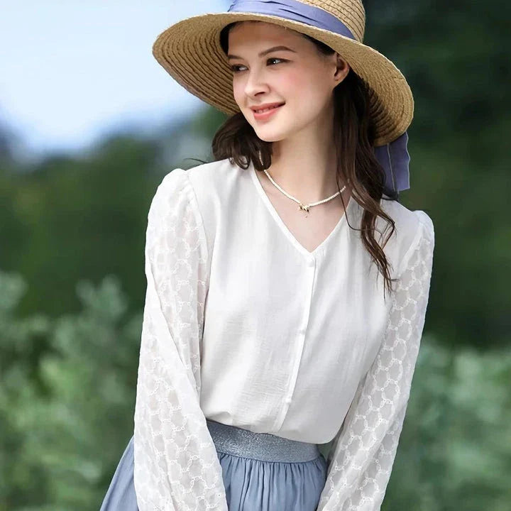 A French-inspired chic v-neck women's blouse in a crisp white colour, featuring a stylish spliced design and a flattering, tailored silhouette.