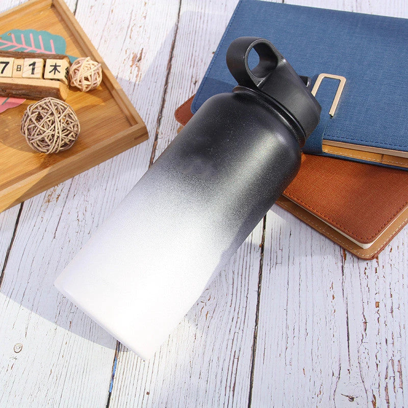 Stainless steel insulated water bottle with wide mouth and push-button lid for hot and cold beverages