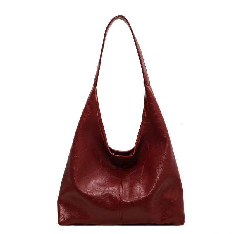 Classic vintage-inspired women's shoulder bag in a range of sophisticated colours, featuring a roomy interior, adjustable strap, and premium materials for timeless British style.