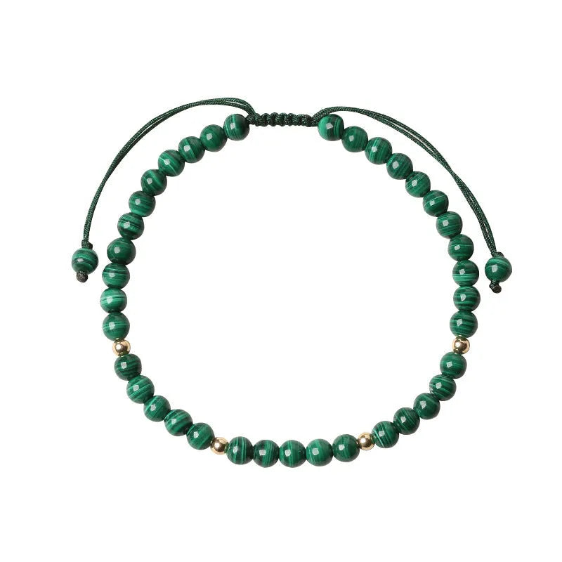 Handwoven green malachite crystal bracelet for women with golden ball accents.