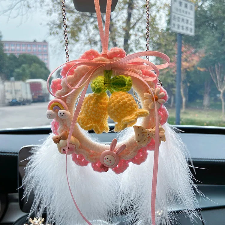 Green woven wool bell orchid car pendant hanging, showing handmade texture and fresh style.