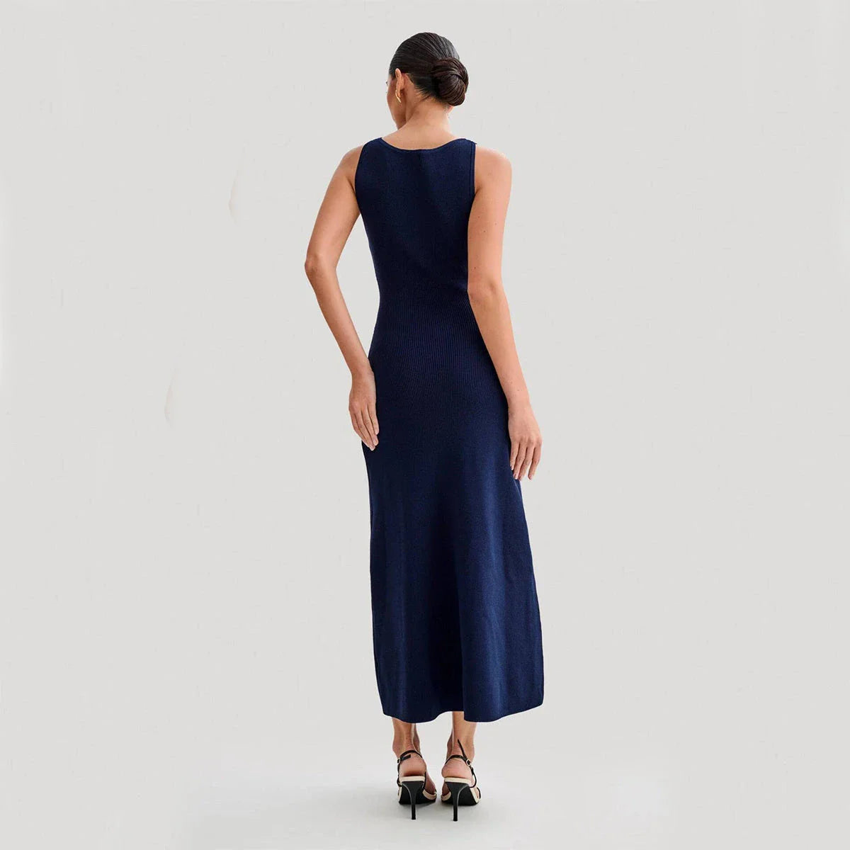 Sleeveless knit dress in apricot and blue colors, showcasing a slim, flattering silhouette and premium polyester construction