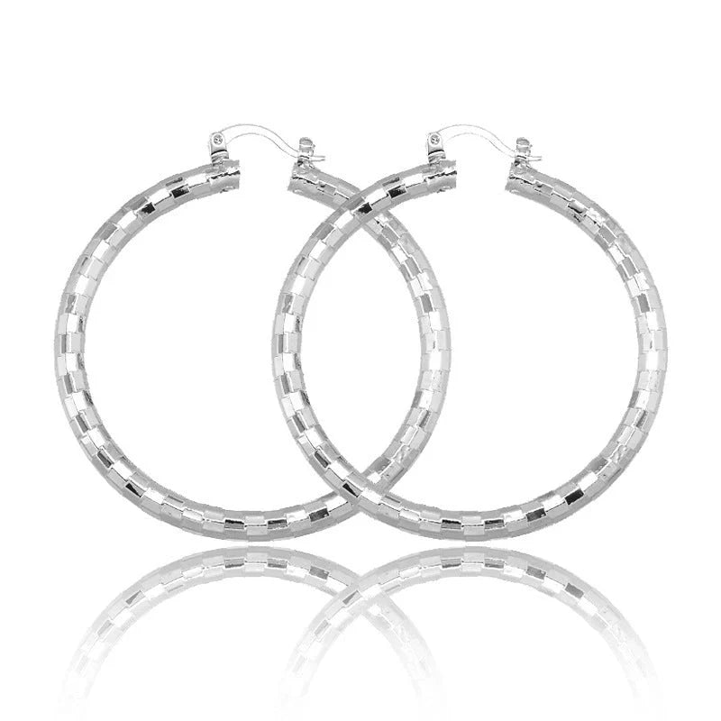 Elegant geometric copper earrings with 18-carat gold plating, featuring a minimalist elliptical design
