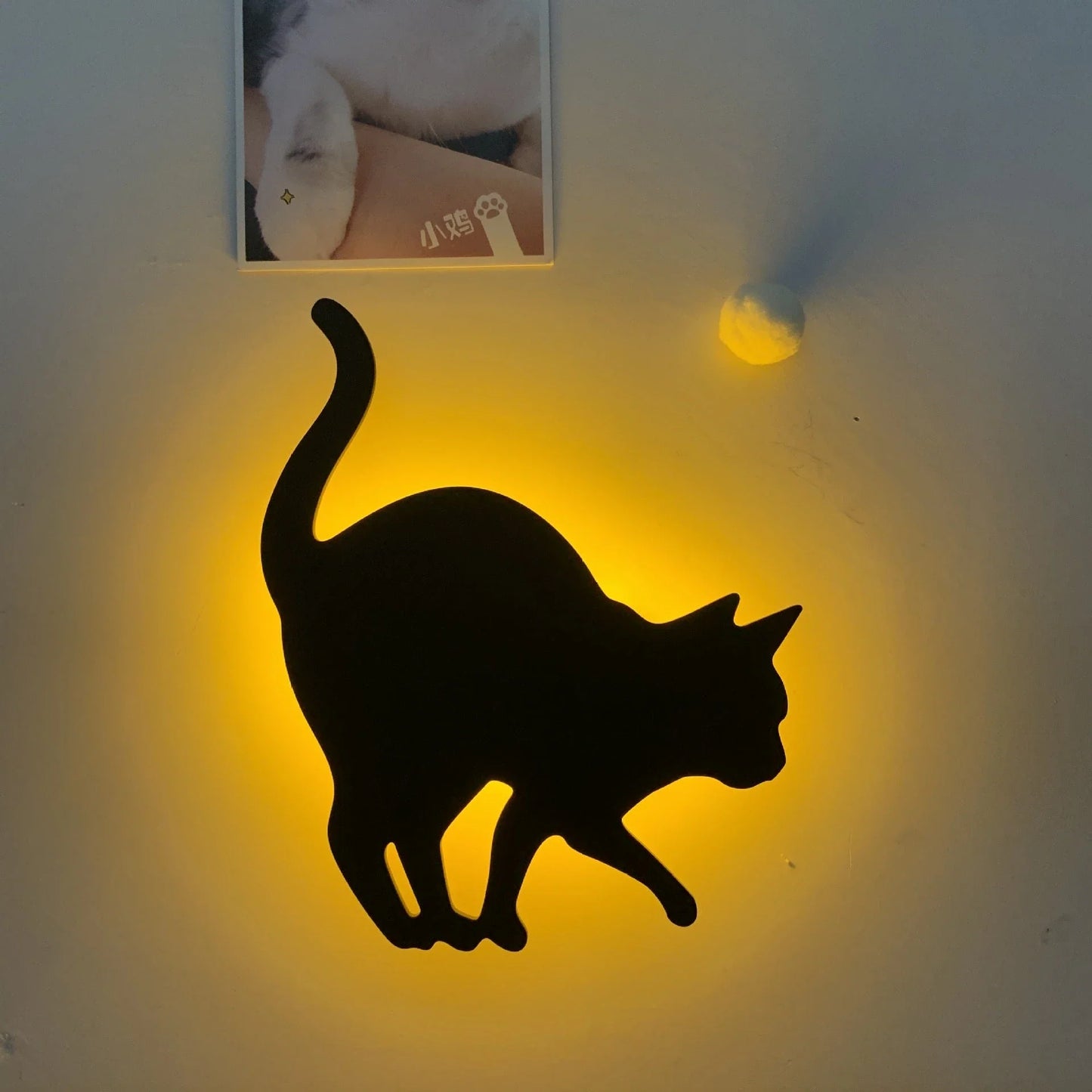 A stylish cat-themed LED lamp that automatically lights up when it detects sound, creating a cozy, ambient glow in a room.