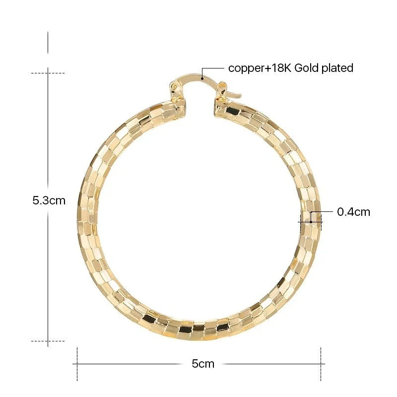 Elegant geometric copper earrings with 18-carat gold plating, featuring a minimalist elliptical design