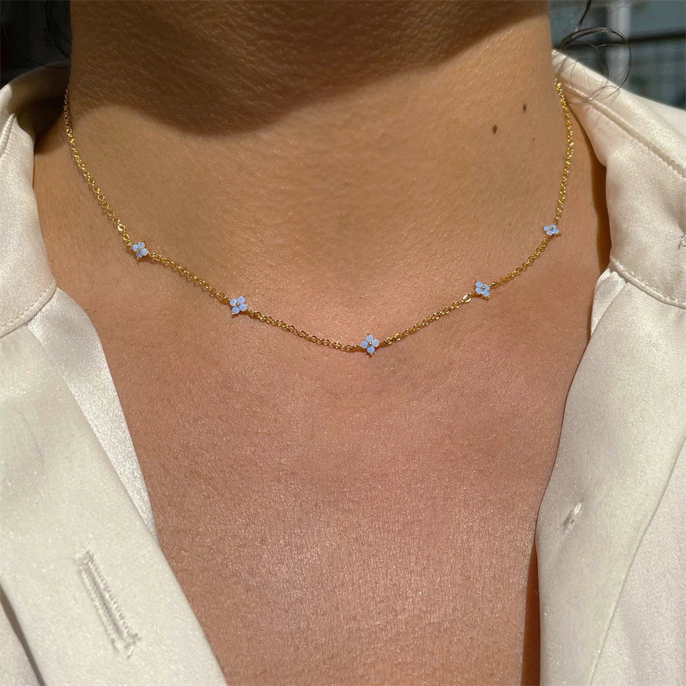 Elegant gold and silver floral necklace with adjustable chain and flower charm, perfect for vacation and beach outfits