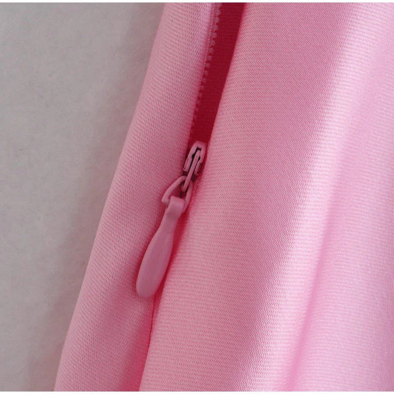Elegant satin slip dress in pink with a square neckline, sleeveless design, and backless detail