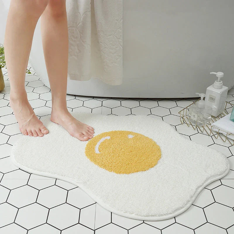 Stylish and absorbent egg-shaped doormat in various sizes and colors, made of plush polyester with a non-slip rubber backing