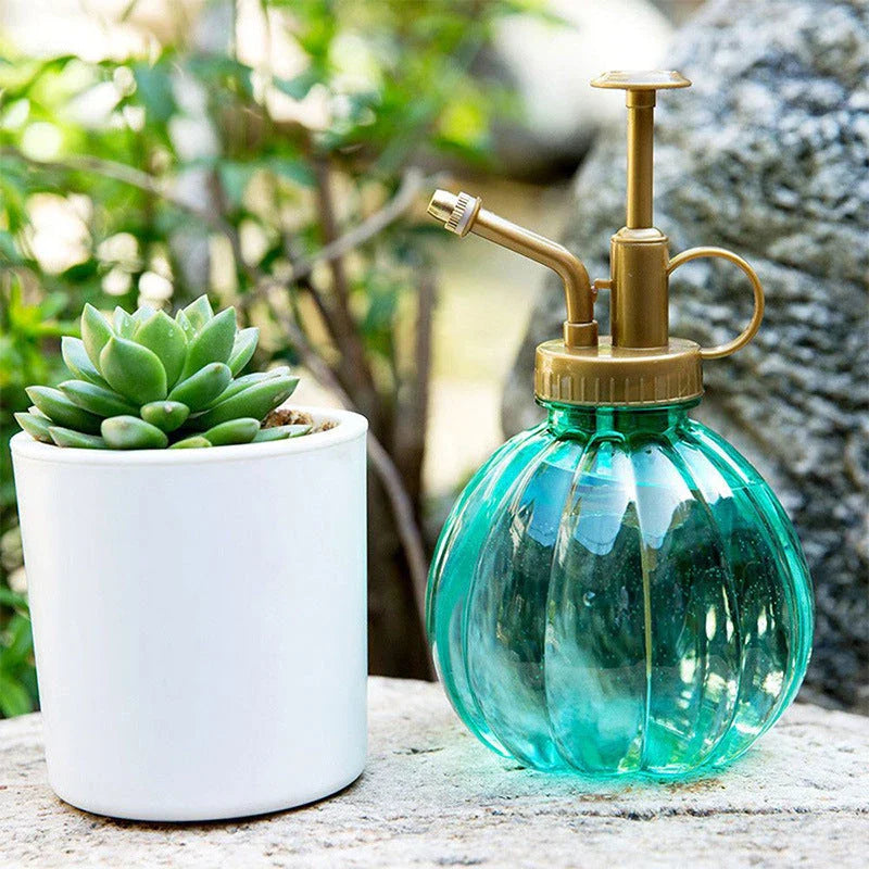 A stylish garden sprayer in a pumpkin shape with a retro-inspired copper pressure bar, designed for watering flowers and plants efficiently.