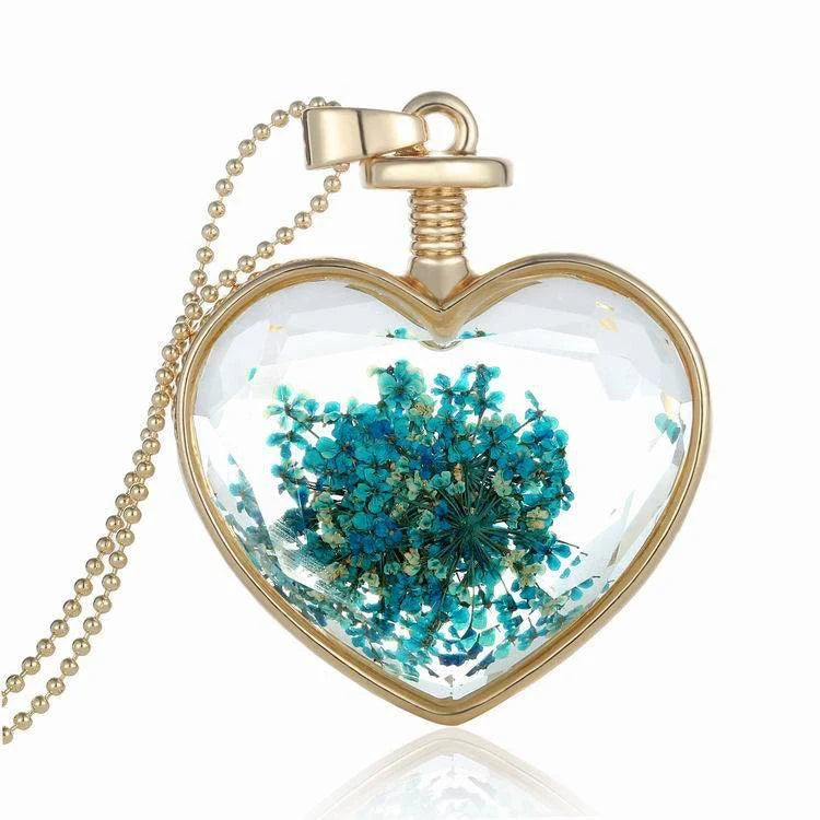 Elegant floral pendant necklace with a dried flower charm on a gold-tone chain