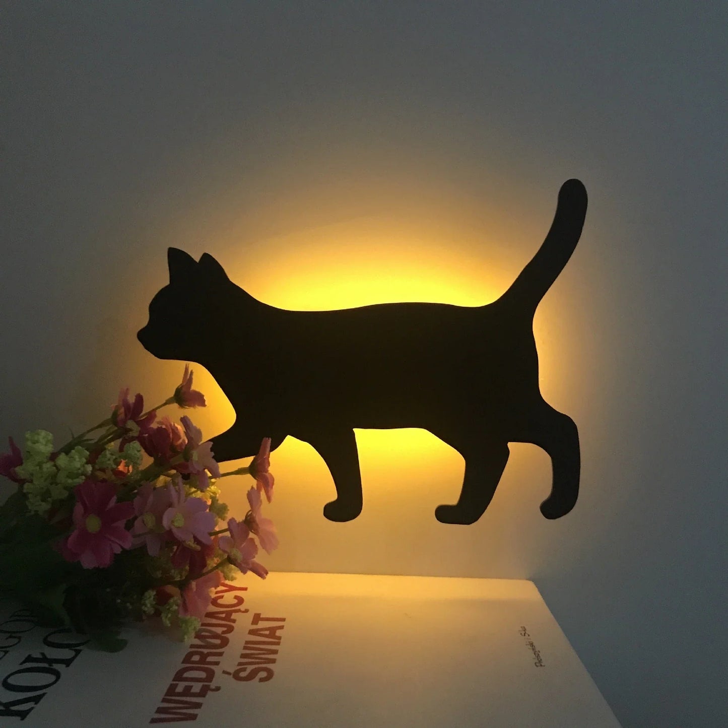 A stylish cat-themed LED lamp that automatically lights up when it detects sound, creating a cozy, ambient glow in a room.