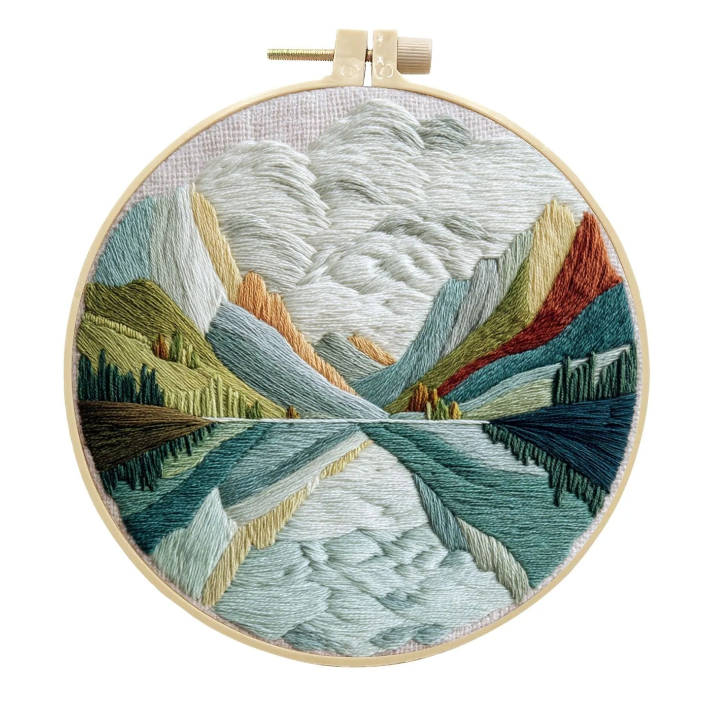 Complete DIY embroidery kit with 15cm bamboo frame, pre-printed landscape fabric, threads, and needles laid out.
