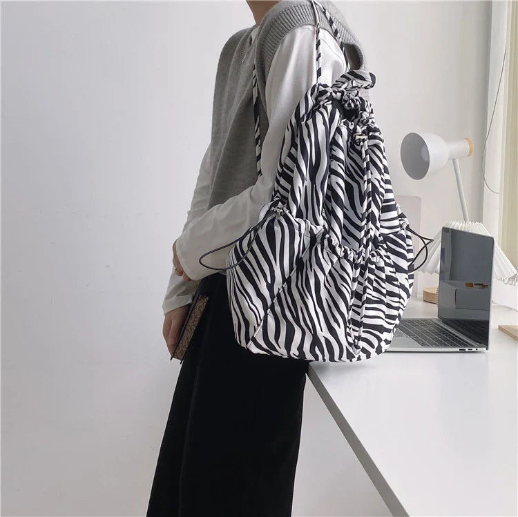 Creative drawstring bucket bag in white, black, brown, and zebra print patterns - a stylish and versatile women's tote bag made of high-quality polyester material