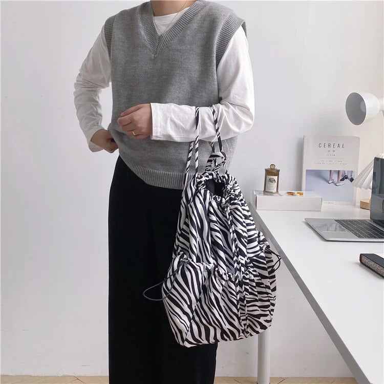 Creative drawstring bucket bag in white, black, brown, and zebra print patterns - a stylish and versatile women's tote bag made of high-quality polyester material