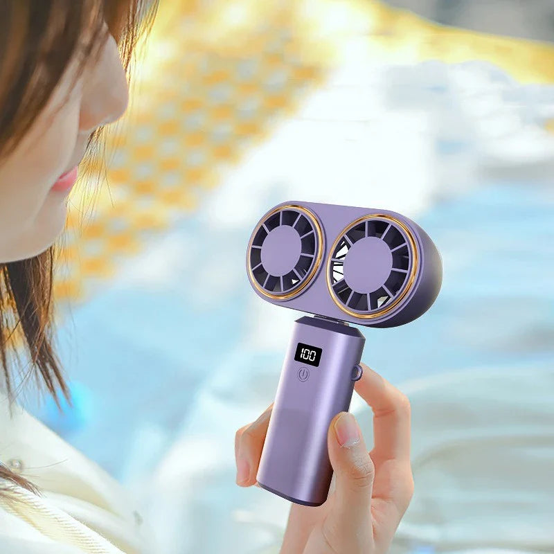 Portable USB-powered handheld fan with foldable design, adjustable speeds, and digital display