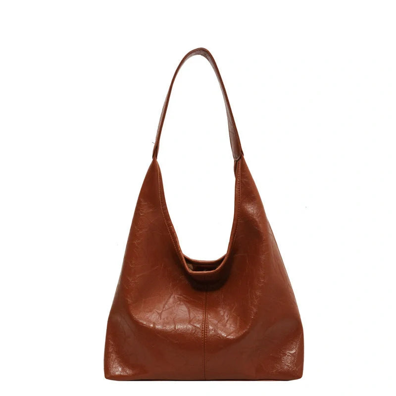 Classic vintage-inspired women's shoulder bag in a range of sophisticated colours, featuring a roomy interior, adjustable strap, and premium materials for timeless British style.