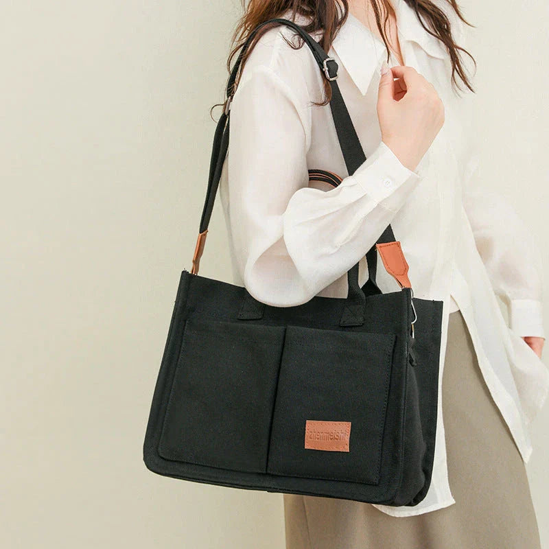 Premium canvas tote bag with multiple pockets, adjustable shoulder strap, and stylish design for everyday use
