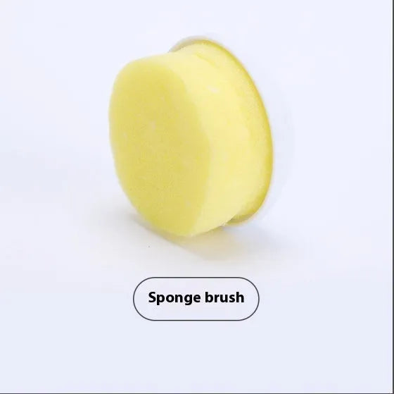 White cordless electric spin scrubber with multiple brush heads on a bathroom tile.